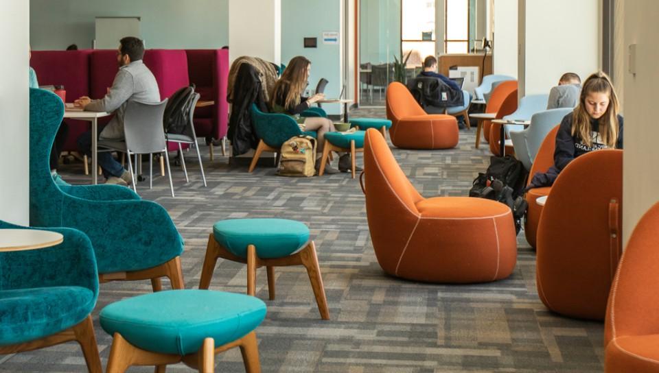 Several students studying in the Commons