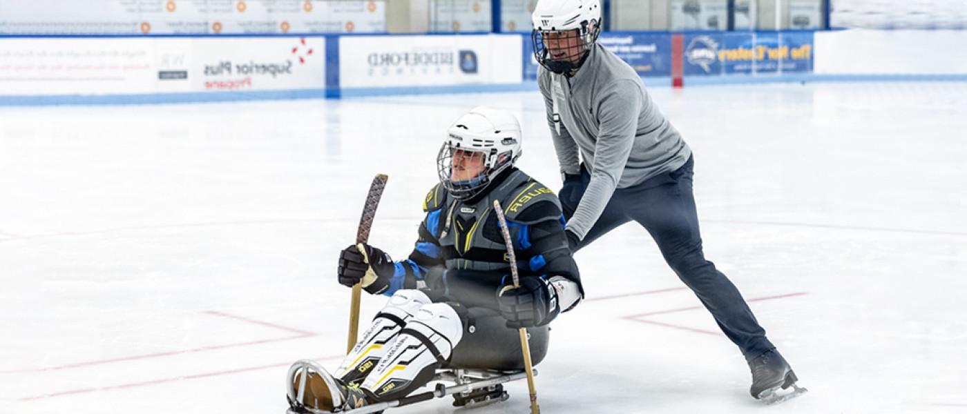 UNE Doctor of Physical Therapy students help out with a Maine Adaptive Sledding event at the Harold Alfond Forum