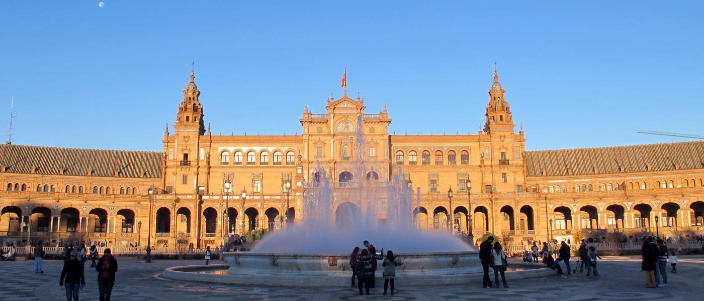 A fountain shoots water into the air in the middle of Plaza day Espana